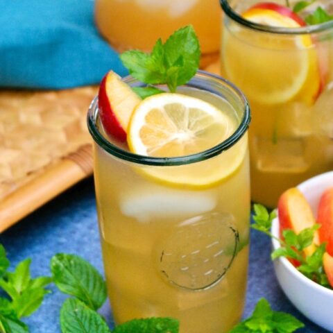 Peach lemonade in clear glasses with lemon slice