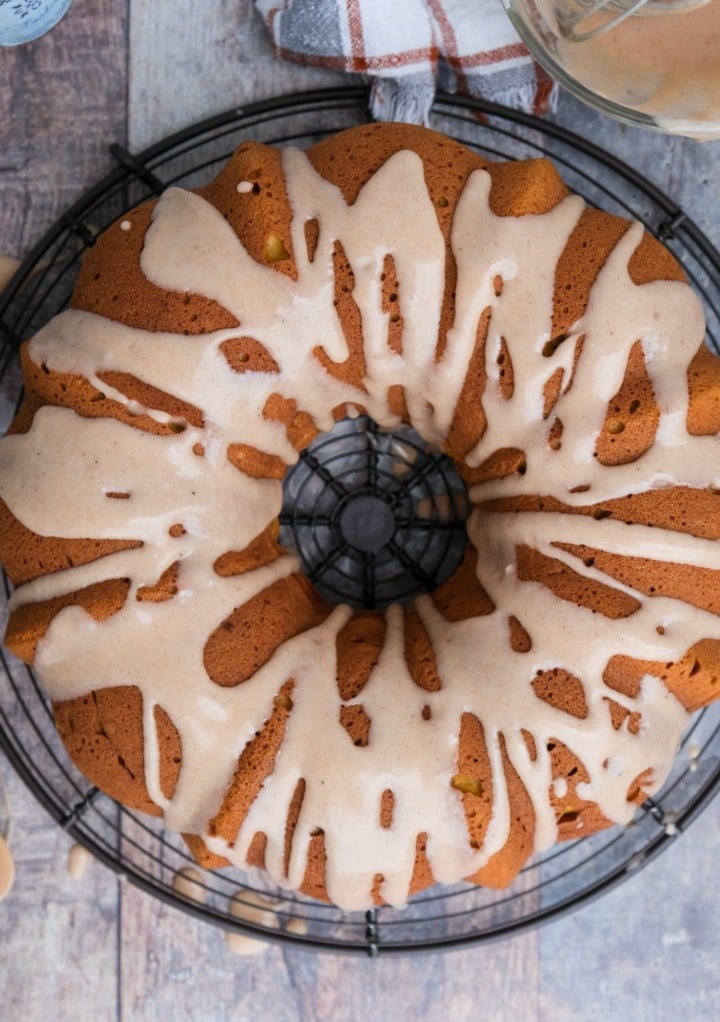 Top view of a bundt cake with a glaze over the cake. 