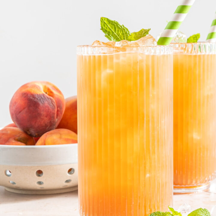 Homemade peach tea in tall clear glasses.