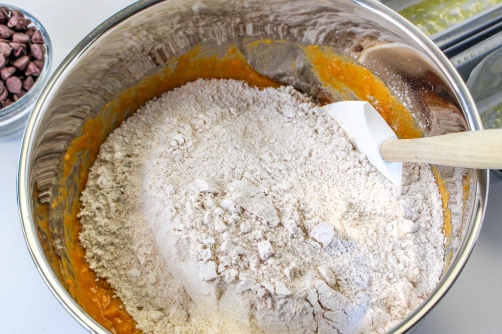 Flour on pumpkin batter in a mixing bowl before combining. 