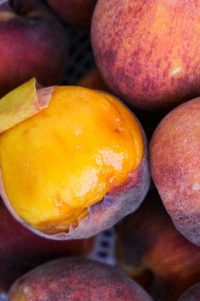 Fresh peaches with part of the skin removed. 