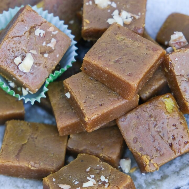 Pumpkin fudge squares with some topped with walnuts.