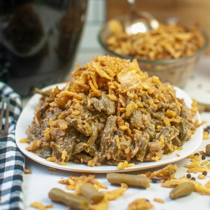 Green bean casserole recipe on a white serving plate that has beencooked in an air fryer.