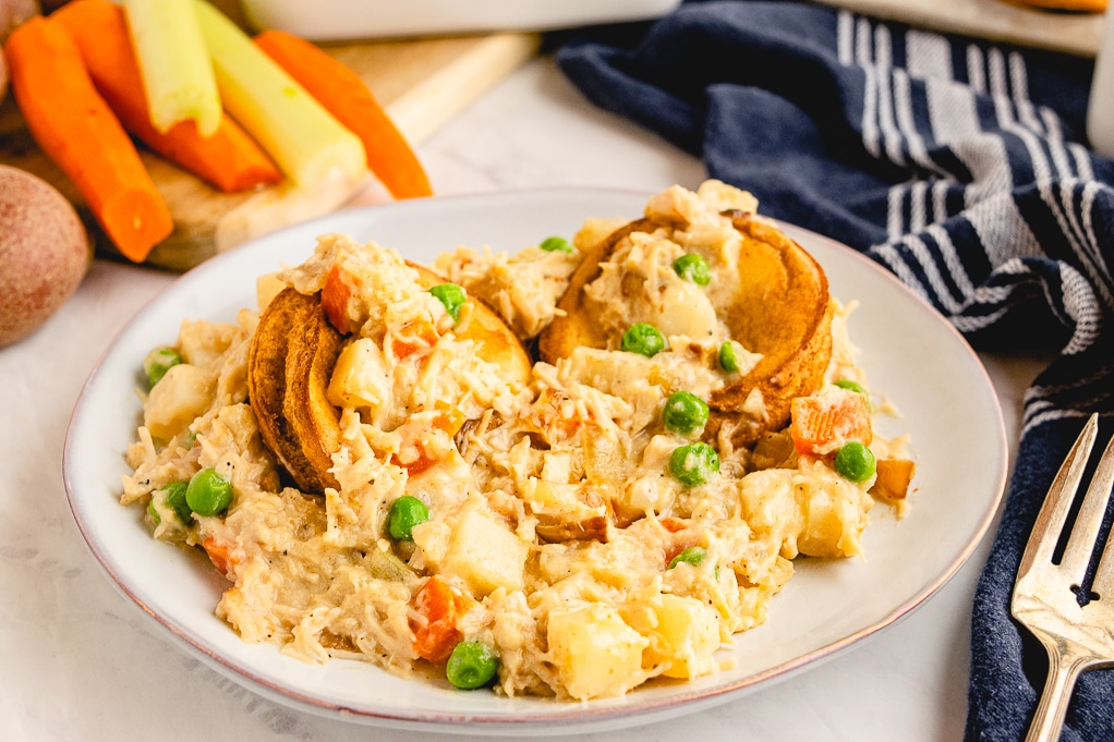 White plate filled with healthier chicken pot pie with popovers. 