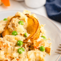 Chicken pot pie on a white plate ready to enjoy eating.