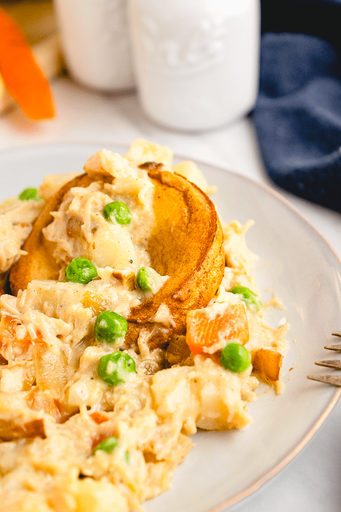 Chicken pot pie on a white plate ready to enjoy eating. 