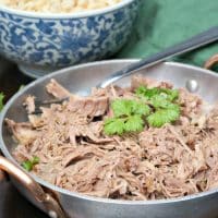 Kalua Pork shredded in a silver serving plate