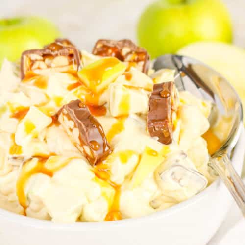 Apple snickers dessert salad in a white serving bowl.