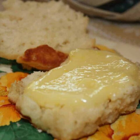 lemon curd spread over homemade biscuits