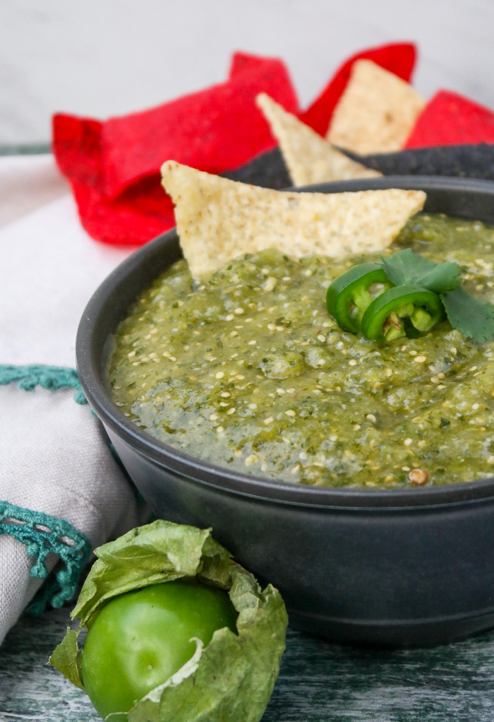 Green salsa made with tomatillos with tortilla chips.