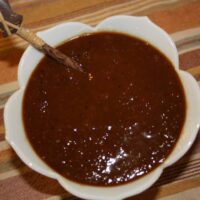 Homemade mango barbecue sauce in a small white bowl