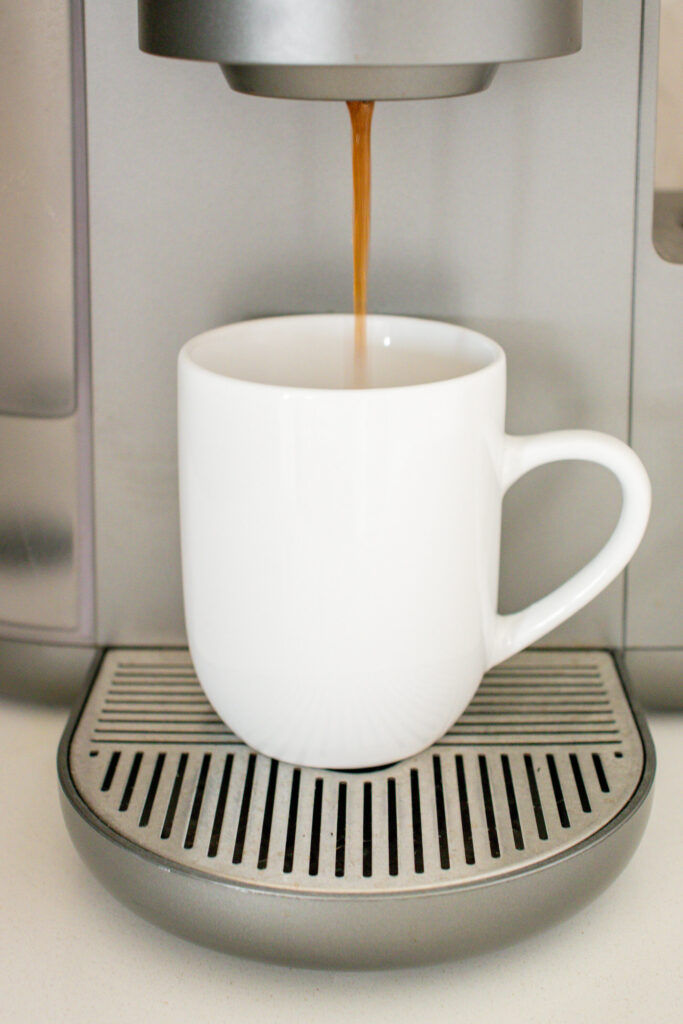 Brewing a cup of coffee in a Keurig coffee maker.