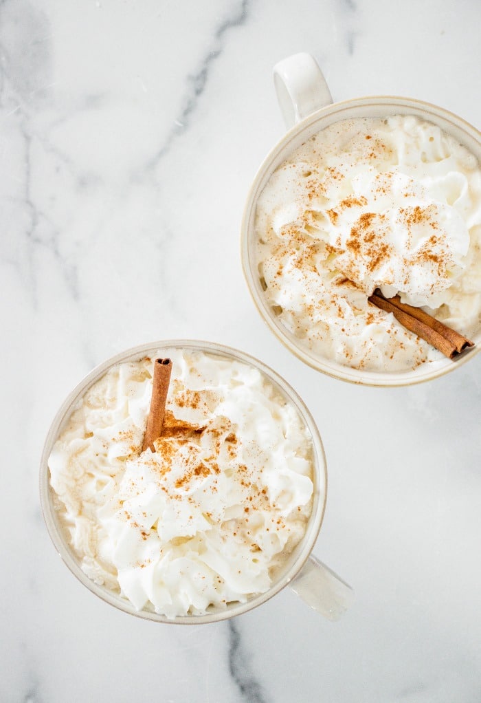 Top view of pumpkin spice latte beverages with whipped cream.