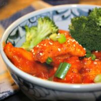 in a blue and white bowl with broccoli.