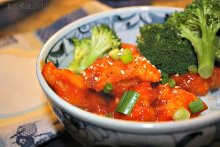 in a blue and white bowl with broccoli.