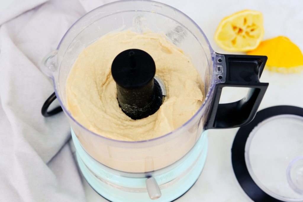 Blended garbanzo beans in a food processor.