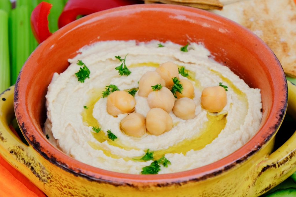 Creamy hummus topped with olive oil and chopped parsley. 