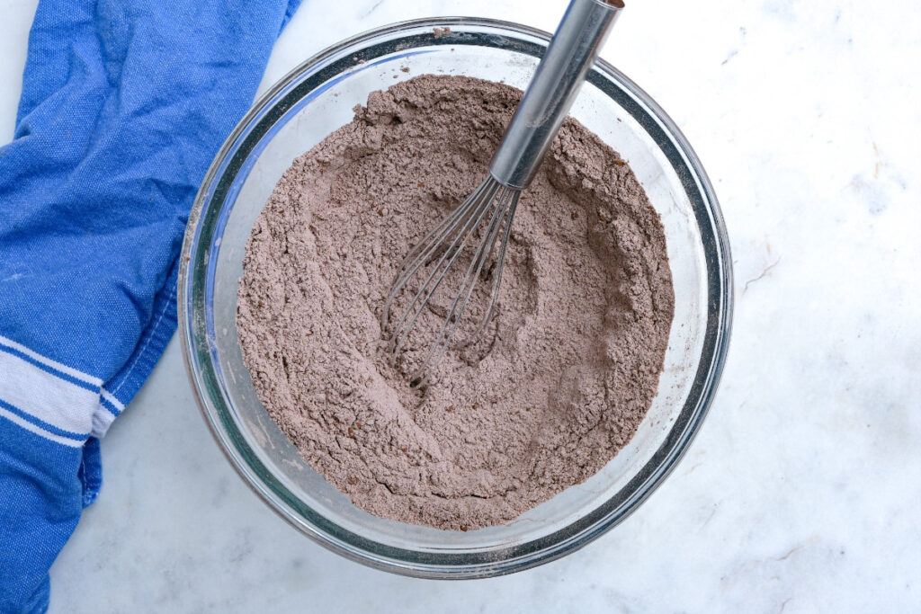 Dry ingredients whisked together in a clear mixing bowl.