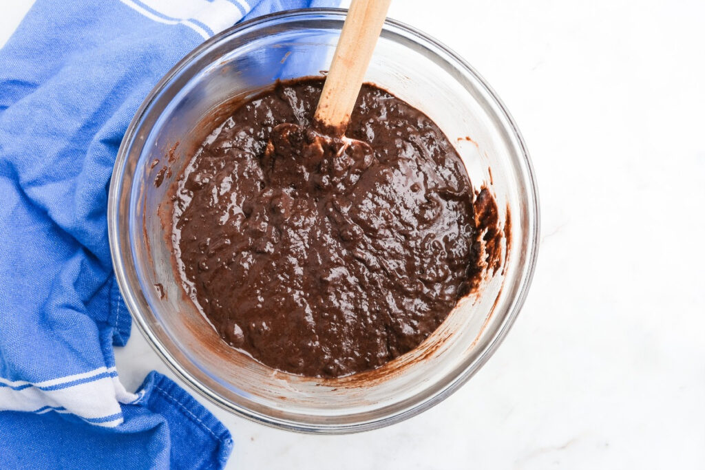 Chocolate donut batter in a mixing bowl before baking. 