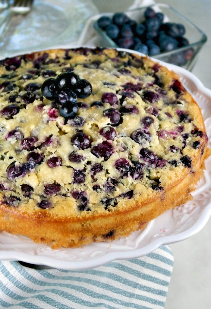 Cooked blueberry coffee cake on a white platter