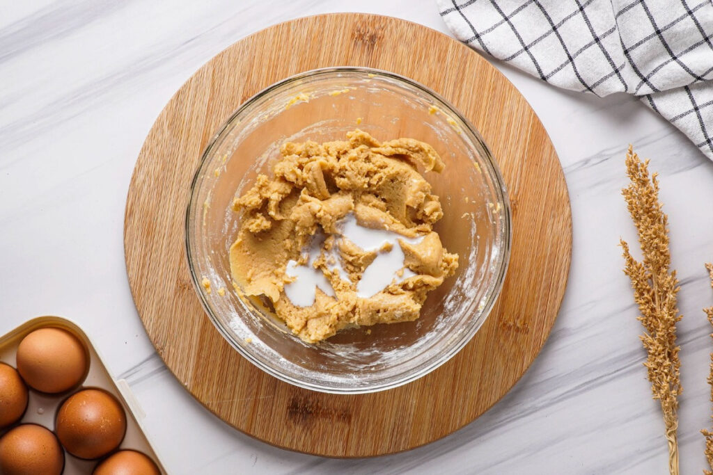 Peanut butter frosting in a mixing bowl before topping on cupcakes. 