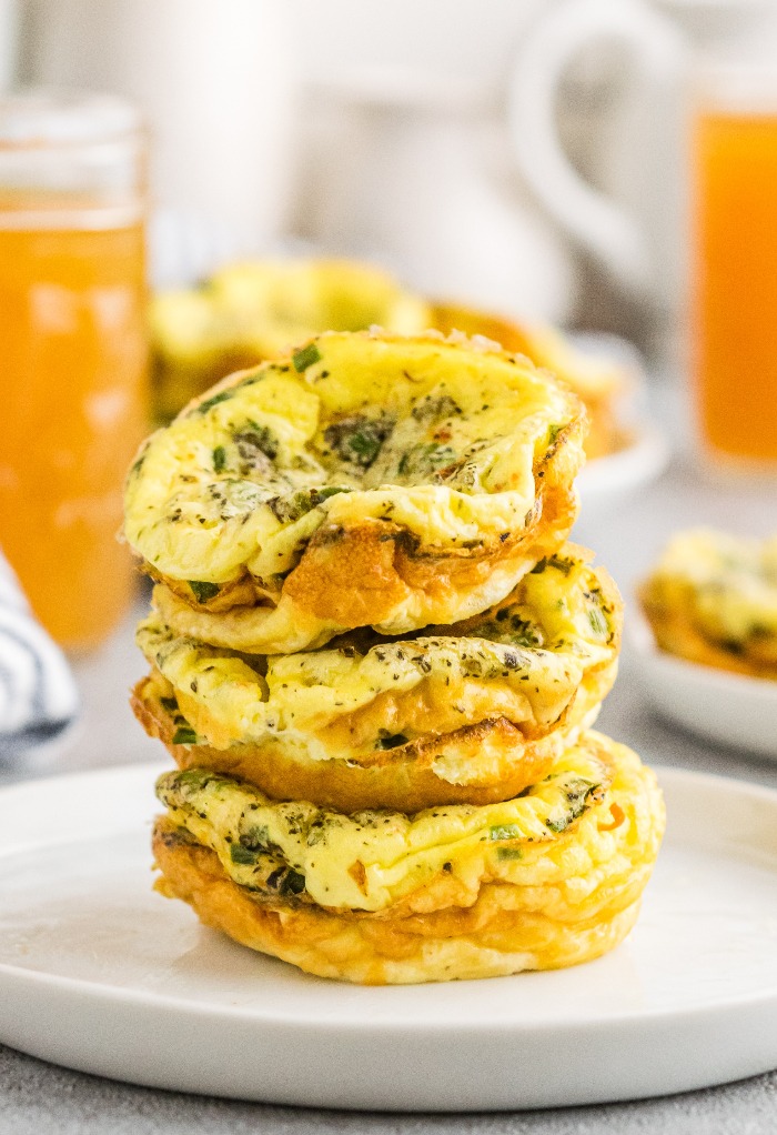 A stack of egg cups on a white plate ready to be eaten. 