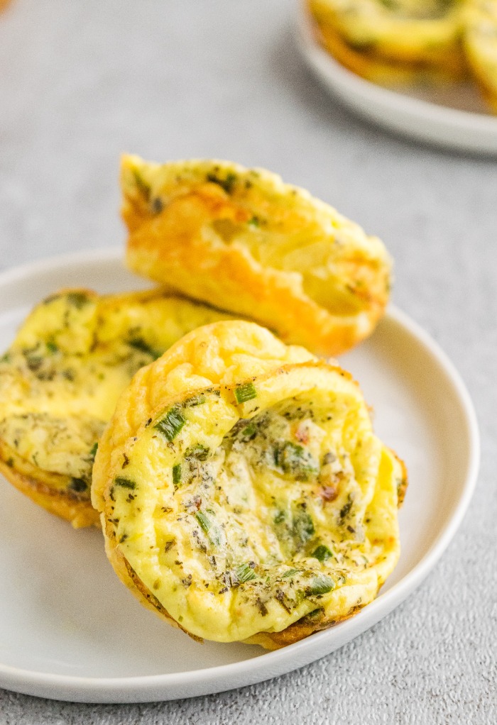 A white plate filled with egg bites ready to be enjoyed. 