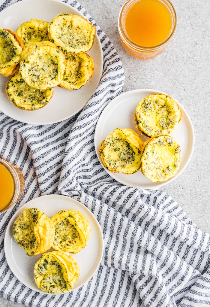 Top view of three plates filled with egg cups ready to eat. 