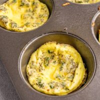 A muffin tin with baked egg cups.