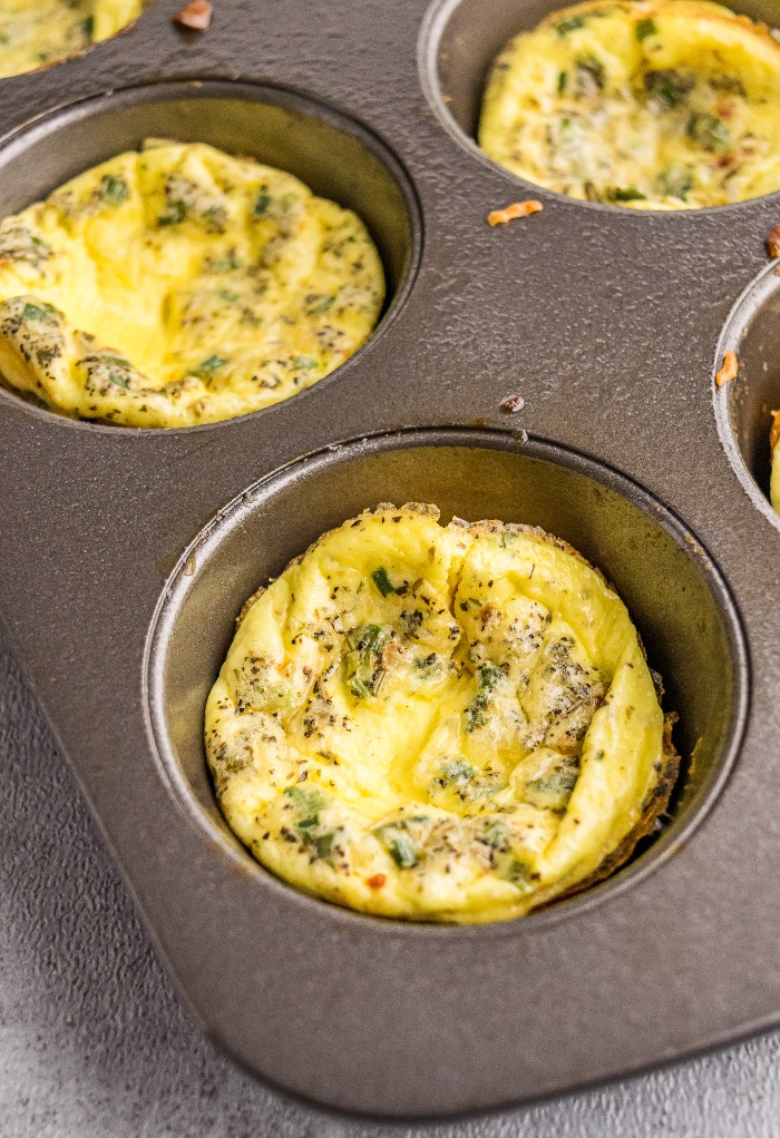 A muffin tin with baked egg cups.