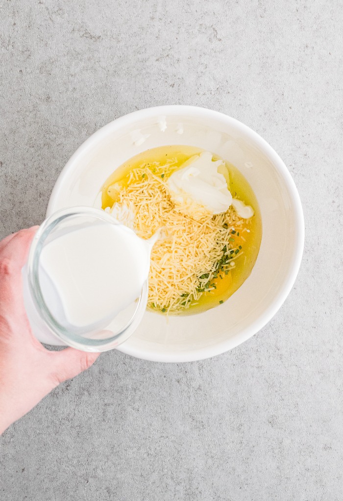 Whisk ingredients for egg muffins in a mixing bowl. 