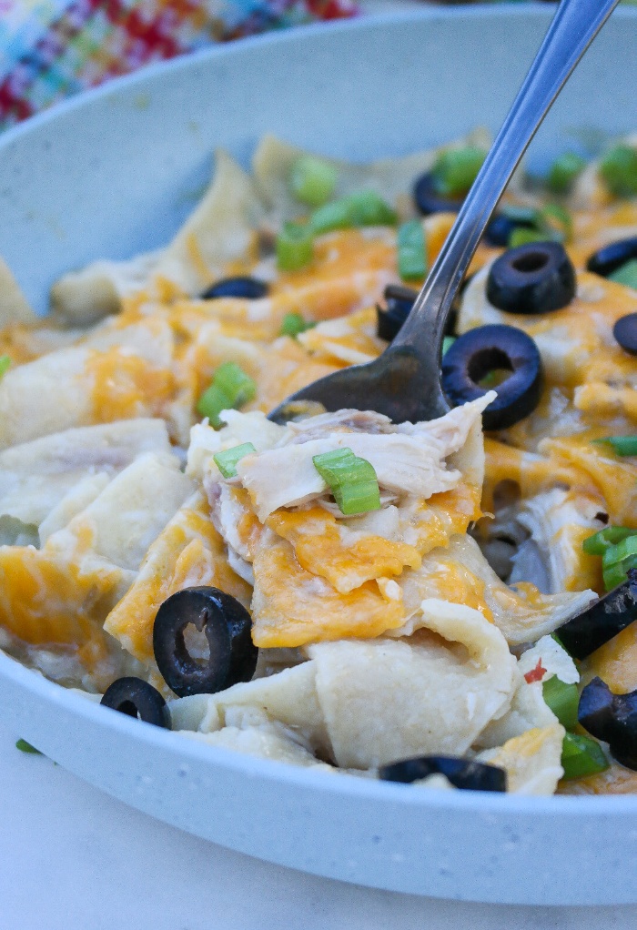 Enchiladas made in a skillet topped with cheese.