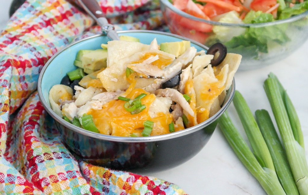 A black bowl filled with enchilada casserole.