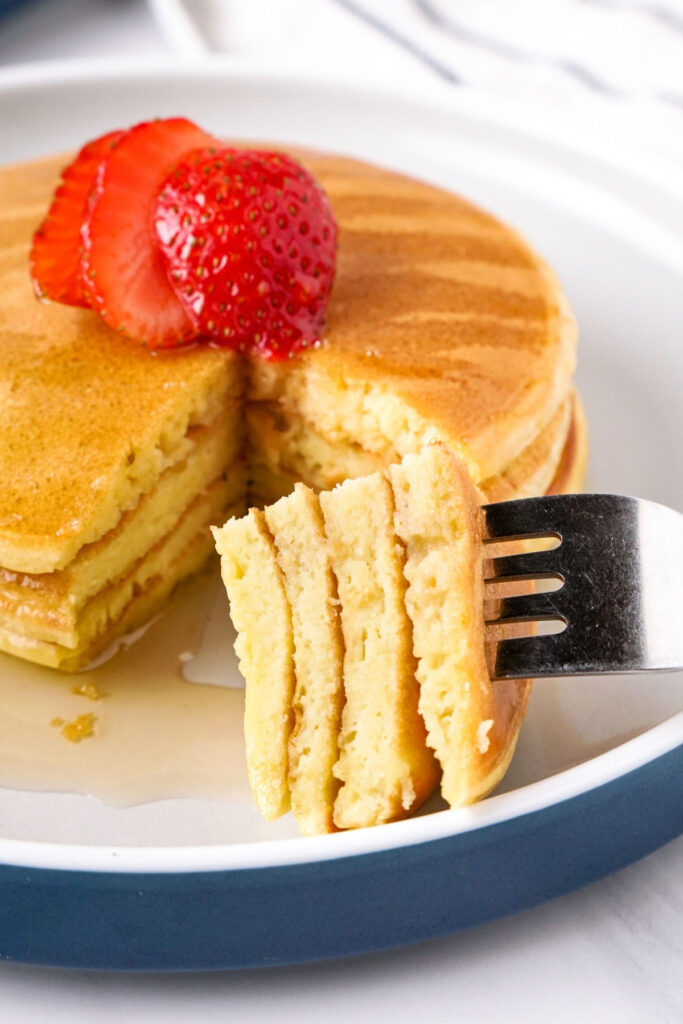 A forkful of pancake with maple syrup. 