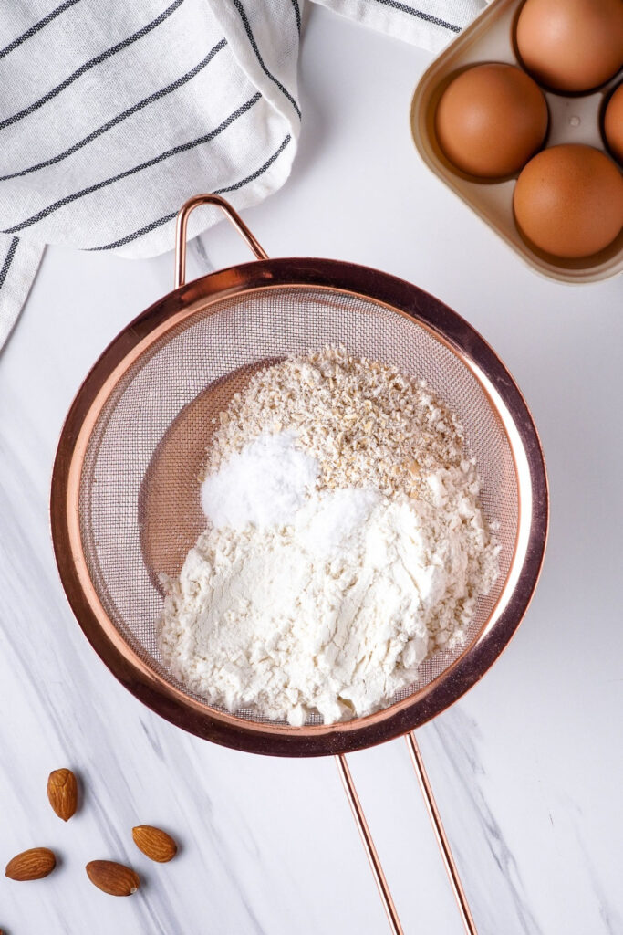 Sift flour over a bowl to make pancakes. 