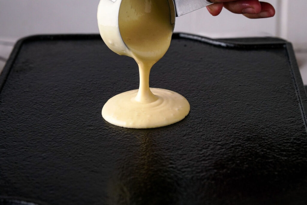 Pancake batter on a hot skillet before cooking. 