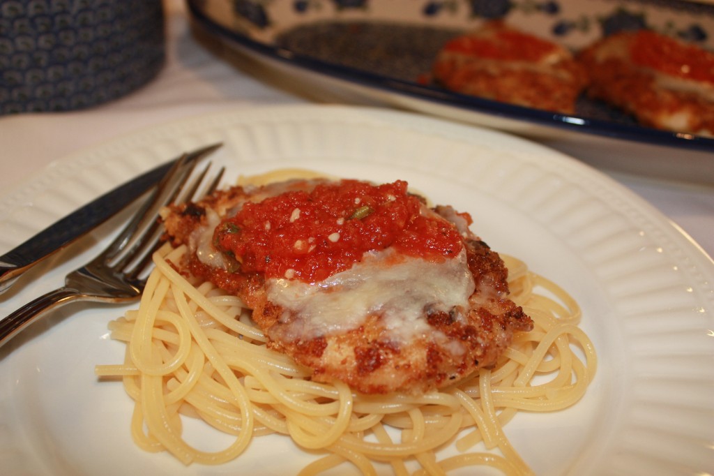 The Best Chicken Parmesan served over a bed of pasta! | www.thefoodieaffair.com