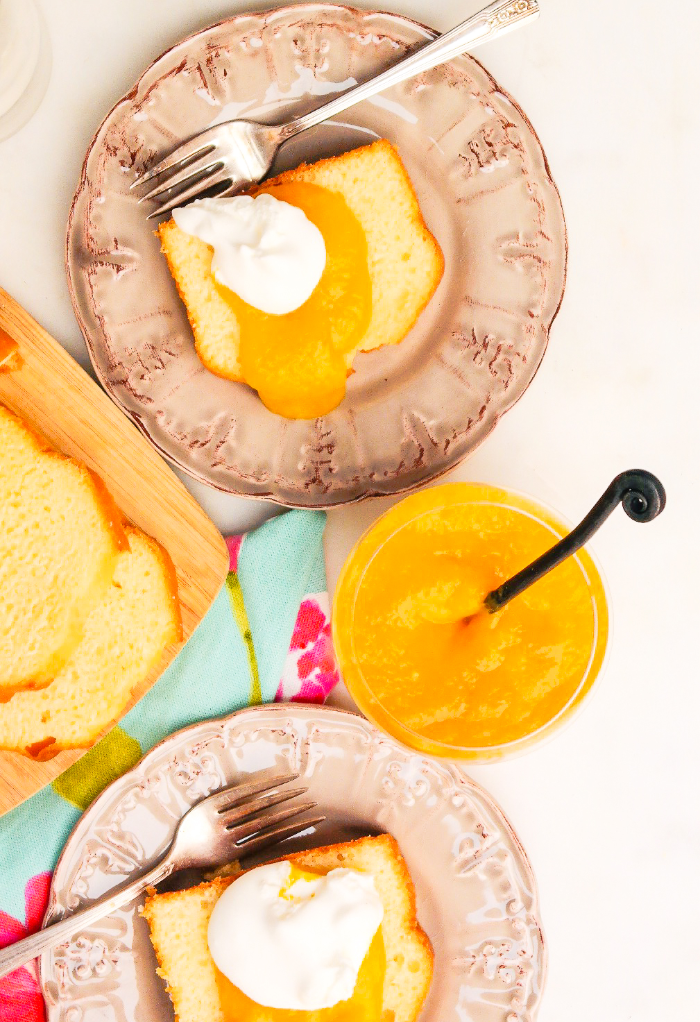 Slices of pound cake topped with mango puree and whipped cream. 