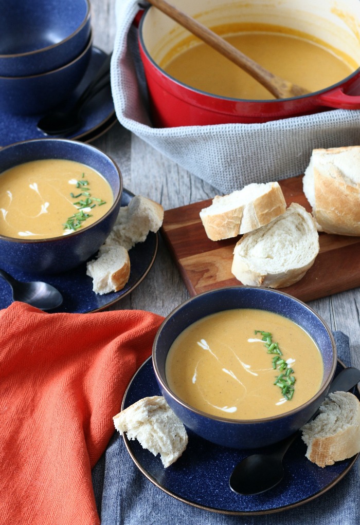 Sweet potato soup recipe dished out into bowls with bread on the side, ready to be enjoyed. 