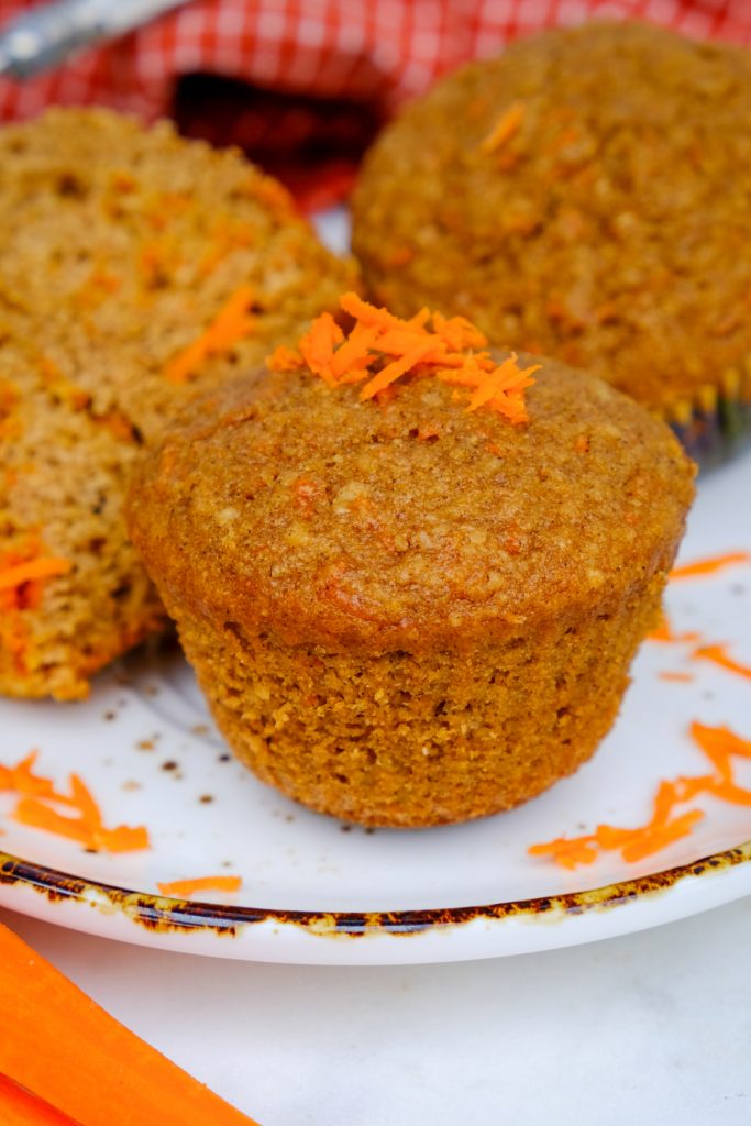 Carrot cake muffins on a white serving dish with a brown rim around it. 