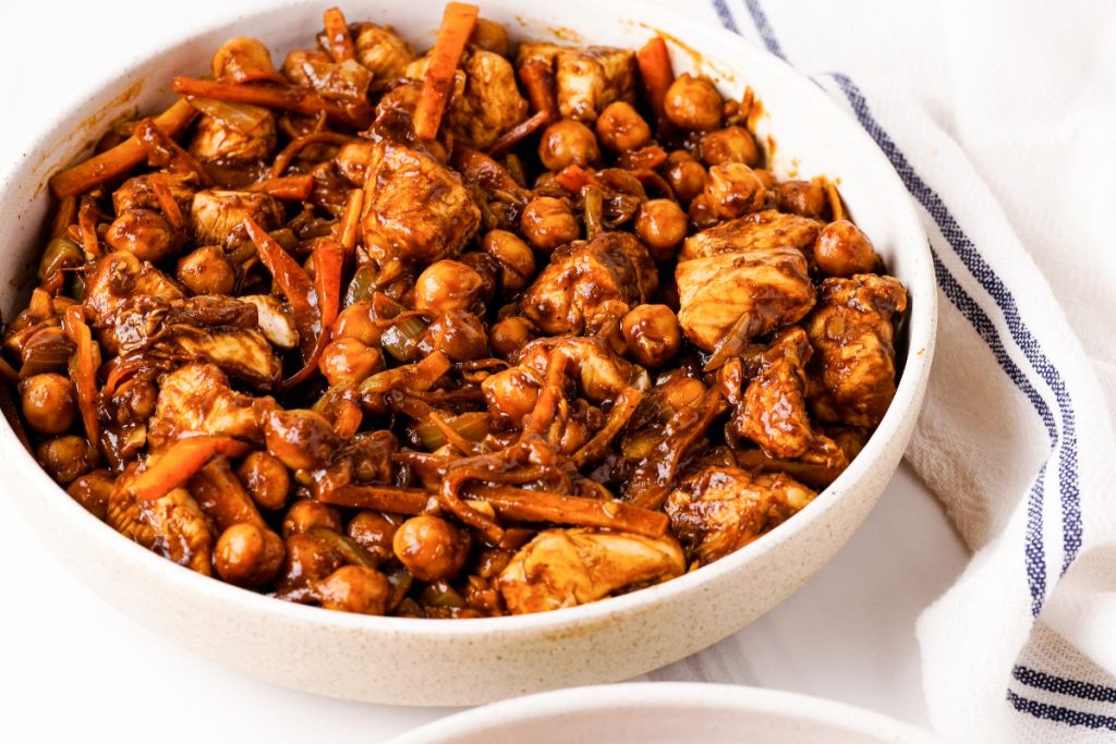 Vegetarian stew with chickpeas in a white serving dish. 