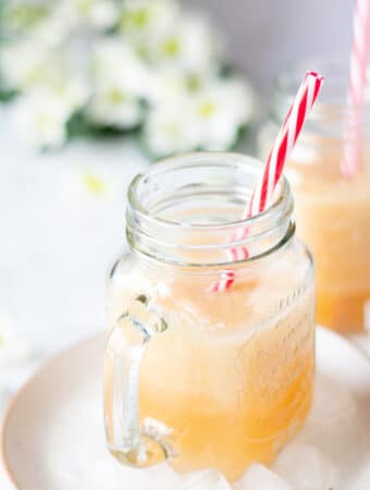 homemade pineapple melon smoothie in a clear mason jar