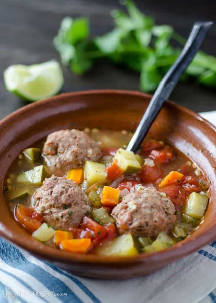 Albondigas with vegetables in a brown bowl