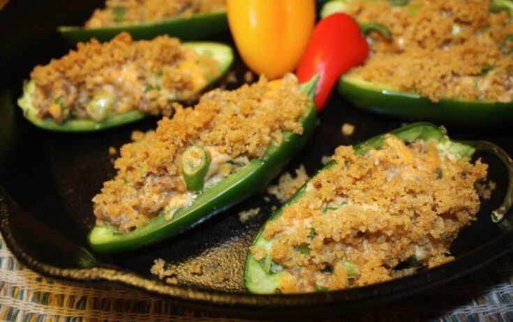 sausage stuffed jalapeños in a cast iron pan