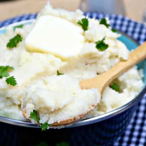 mashed cauliflower in a black serving bowl