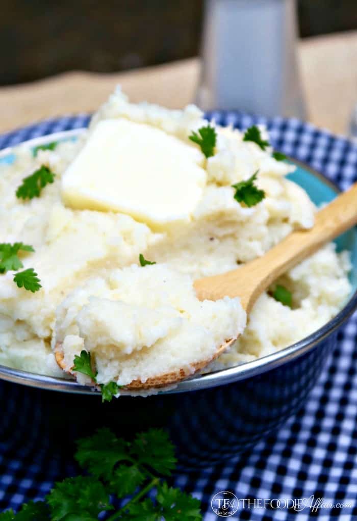 mashed cauliflower in a black serving bowl