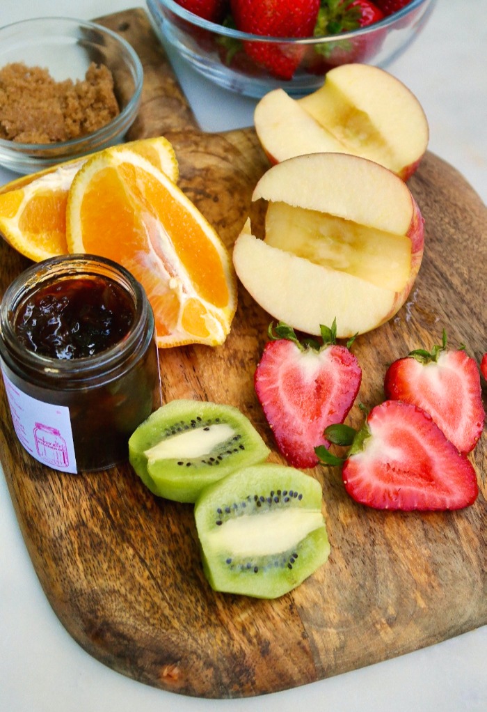 Ingredients for fruit salsa on a cutting board. 