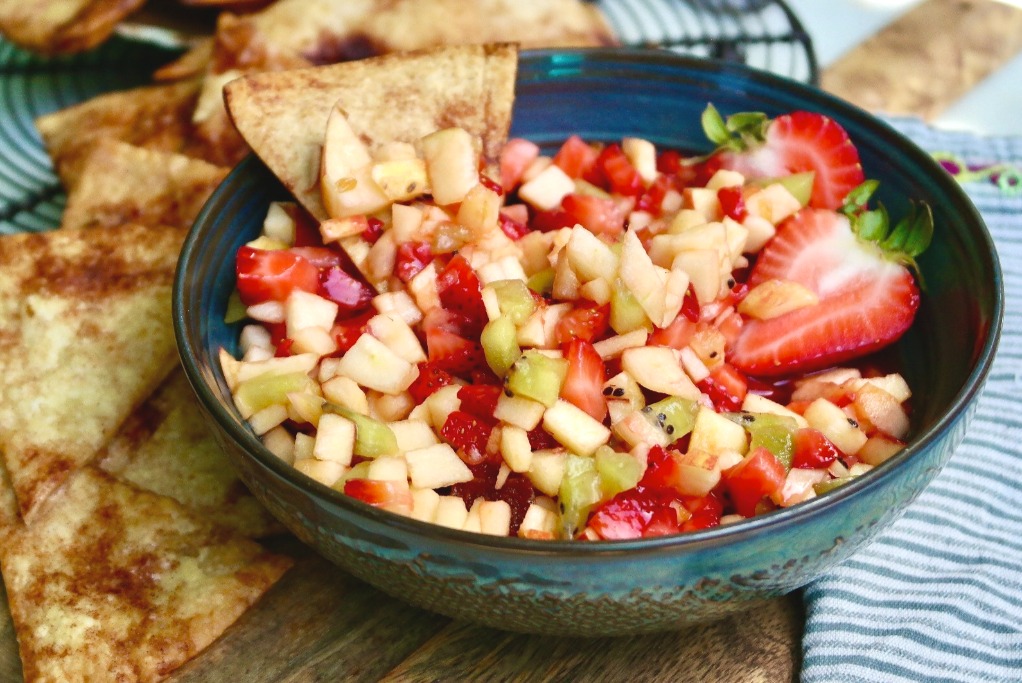 A blue green bowl of fresh fruit salsa. 