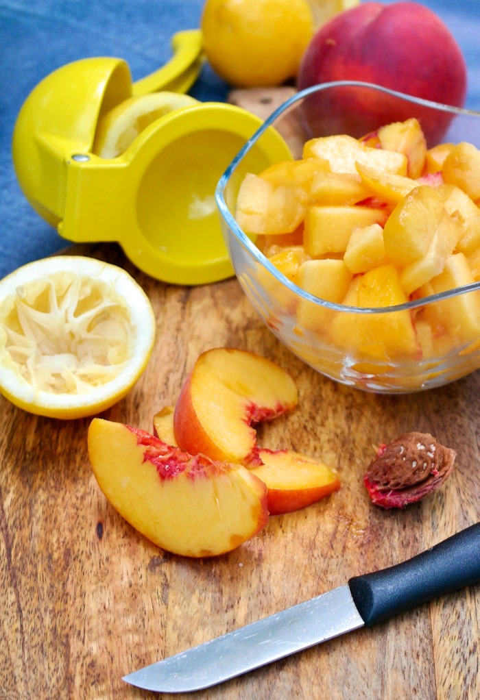 Fresh diced peaches on a cutting board