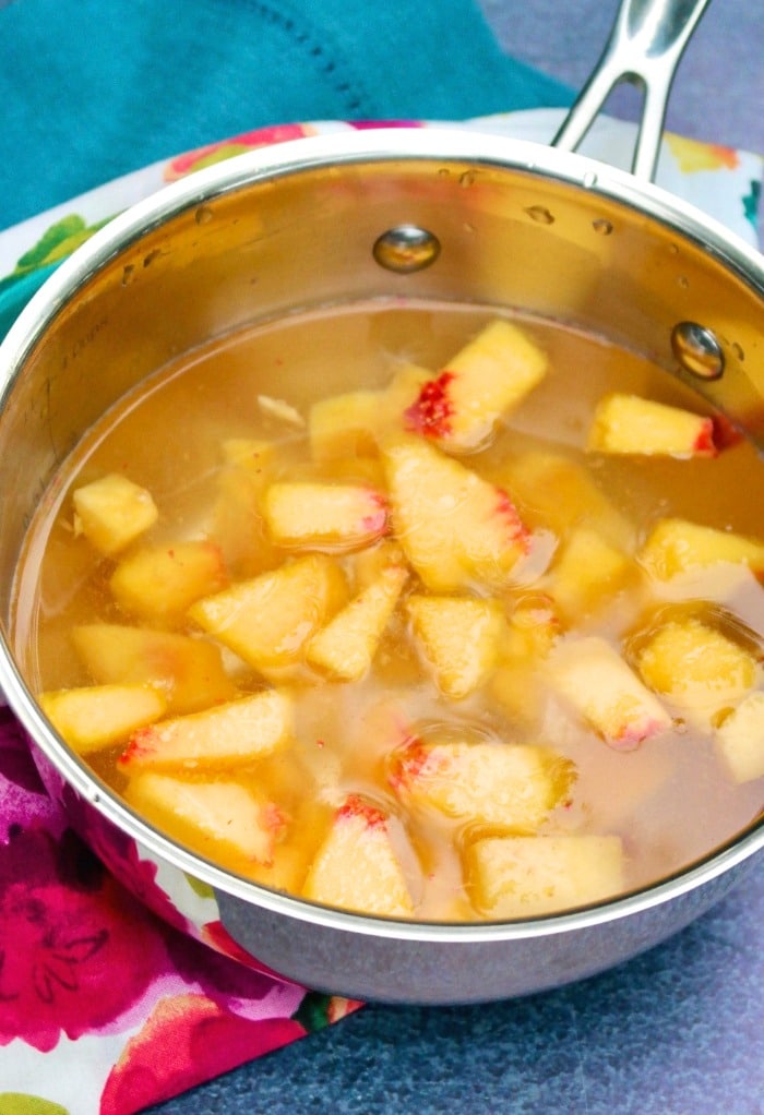 Water and diced peaches simmering